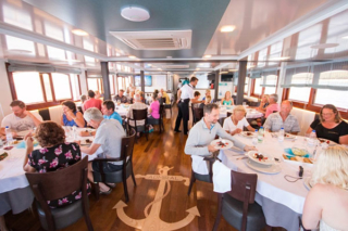 Guests dining aboard a Croatia small ship cruise